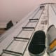 The roof ladder rungs are simply bolted to the roof panels through the regular bolt holes, with steel-back neoprene washers installed under all sections to guard against moisture. This ladder is finished. The safety ring will complete the rungs.