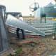Roof sheets are brought in one at a time, and distributed around the perimeter of the first ring, until there are four ready.
