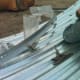 Bolts are inserted into the safety ring sections before taking each section up onto the roof. Steel-back neoprene washers are put on under all ring sections to guard against moisture.
