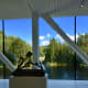 Large panoramic windows open up to lots of natural light and beautiful views of nature and the trout river, Randselva. In the foreground is Pedro Reyes's sculpture "Navaja Suiza VIII (Swiss Army Knife VIII)", 2014.