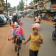 A girl with cattle in Calangute Market, Goa