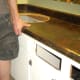 Carefully lift the countertop up and off the cabinets.