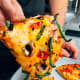 Homemade veggies pizza. We enjoy eating pizza while watching a show. I think everybody is doing that.