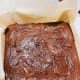 Transfer the batter into a parchment paper-lined square baking dish.