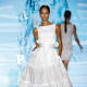 Ruffles replaced with ribbons, boat neckline, belted waistline, full skirt.