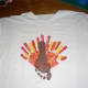 Now repeat procedure with brown paint and child's FOOT. Make sure the heel is up to make the turkey's head. The child's toes will be the turkey's feet. Wash child's foot and let paint dry.