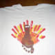 Now paint 2 white circles for the turkey's eyes. And paint a red shape for the waddle. Let paint dry.