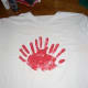 Help your child rub his or her hand in red paint (a paper plate works well) and make 3 handprints in a fan pattern. Wash hands and let paint dry.