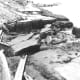 Landslide and slumping damage to State Highway 287, along the shore of Hedgen Lake. Montana, caused by the August 18, 1959, earthquake. (Photograph by J.R. Stacy.)
