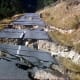 Hebgen Lake, Montana, Earthquake August 1959. Close-up of fractured Highway 287 man inspecting damage