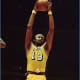 Wilt pulls down one of his 22.9 rebounds per game!