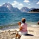 Using the boat ramp area as a seat while viewing the action at Jackson Lake in the Tetons.