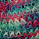 Close up of the figure eight with only one yarn done in multi-colored yarn.