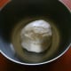 Place the dough in a greased bowl, cover, and allow it to rise for 2 hours in a warm location.
