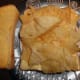 One packet of crisps on a slice of buttered bread