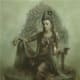 Seated Kuan Yin Bodhisattva holding a vase with a willow branch