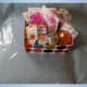 Place the cellophane underneath the basket, with enough on each side to cover the top of the gift basket.