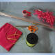 Gather your gift basket supplies: clear cellophane, scissors, ribbon, tape, and tissue paper.