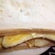 Gently pressing the bread down on top of the crisps and banana to firm