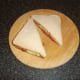 Bacon, tomato, onion and cheesse sandwich is sliced and ready to eat