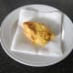 Deep fried chicken is drained on kitchen paper and rested