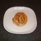 Onion rings laid on turkey bacon