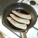 Bacon is fried in a little oil