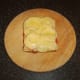 Cheese is melted over the bacon, onion and tomato