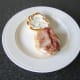 Bacon is added to the bottom half of the roll