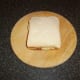 The second slice of bread tops the meklted cheese