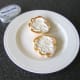 Cream cheese is spread on toasted roll