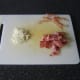 Excess fat is cut from the bacon rashers before they are roughly chopped