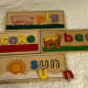 This is the Melissa & Doug See & Spell. Each board has a three-letter word on one side and a four-letter word on the other.