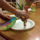 Glue dried coffee filter to paper plate.