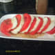 Drizzle dressing or olive oil over sliced tomatoes