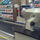 A grocery store uses a conveyor belt to move items toward the cashier for checkout.
