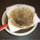 Duck stock is passed through a paper lined sieve to remove smallest impurities and fat