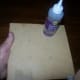 Apply glue to the bottom of the stand when the sticks are in place.