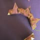Turn tiles over. Start with your dab of glue on the right tip as shown above at the green arrow. Place the left tip on your dab of glue. Work around gluing each piece to the next, forming an octagon.