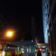 The tall building in the background is clearly visible against the night sky.