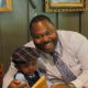Don and his son Jamin, enjoy a laugh as they have dinner together at a local restaurant after the convention.