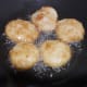 Frying the vadas till they are crisp and golden brown