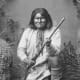 This photo of Geronimo kneeling with his rifle taken in 1887 -