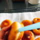 Using a drinking straw, pierce a small hole in the side of each doughnut.