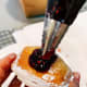Squeeze a small bit of jam into each donut.