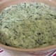Pour the spinach and Parmesan mixture into a 2-quart well-buttered or sprayed soufflé dish to be baked in the oven.