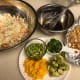Ingredients assembled- cabbage, dressing, toasted noodles & almonds, green onions, avocado, mango, and edamame