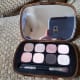 Along with the eight eye shadows, the case contains a high quality full-sized mirror and a double-ended brush with one dense, full side for packing on color and one narrower side for lining and smoking shades out.