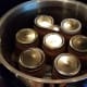 Fill with water a couple inches above your jars.