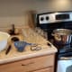 Now it's time to set up your canning station. You'll need pint canning jars with lids and rings, a canner, a pot of boiling water, a canning kit and a ladle.